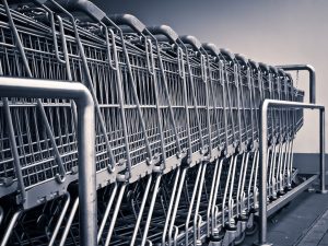 a row of metal grocery shopping carts stacked together