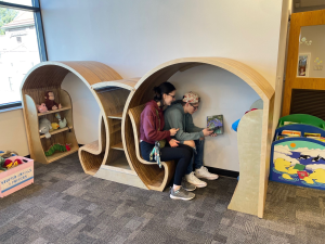 children sitting inside modular furniture, reading