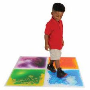 small child walking on colorful floor tiles